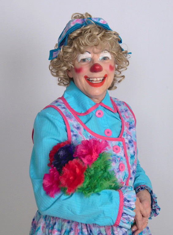 Rainbow the Clown holding flowers