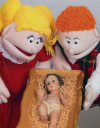 Two puppets look at Jesus in the manger