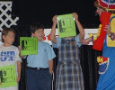 Rainbow, with an oversized phone, and children with 9-1-1 signs