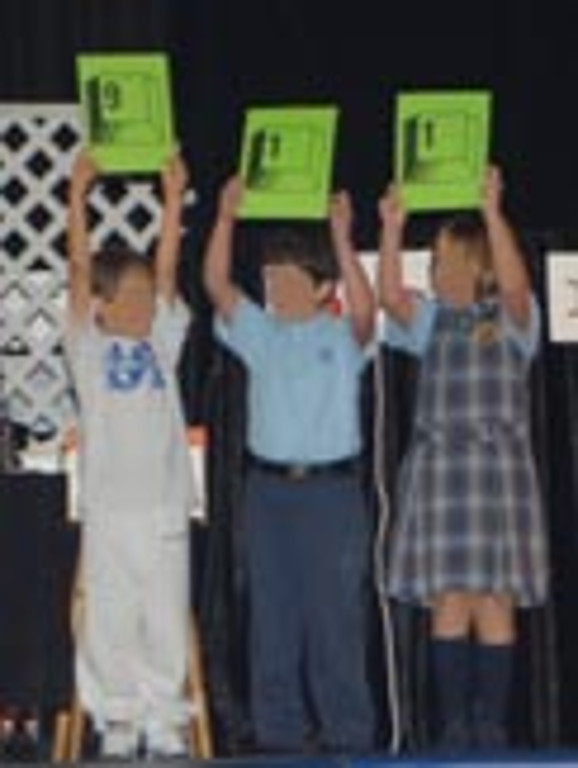 Three children hold up signs showing 9-1-1