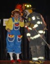 A firefighter in full gear talks to Rainbow