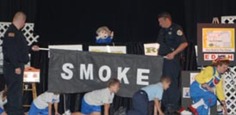 Children follow Rainbow crawling under smoke